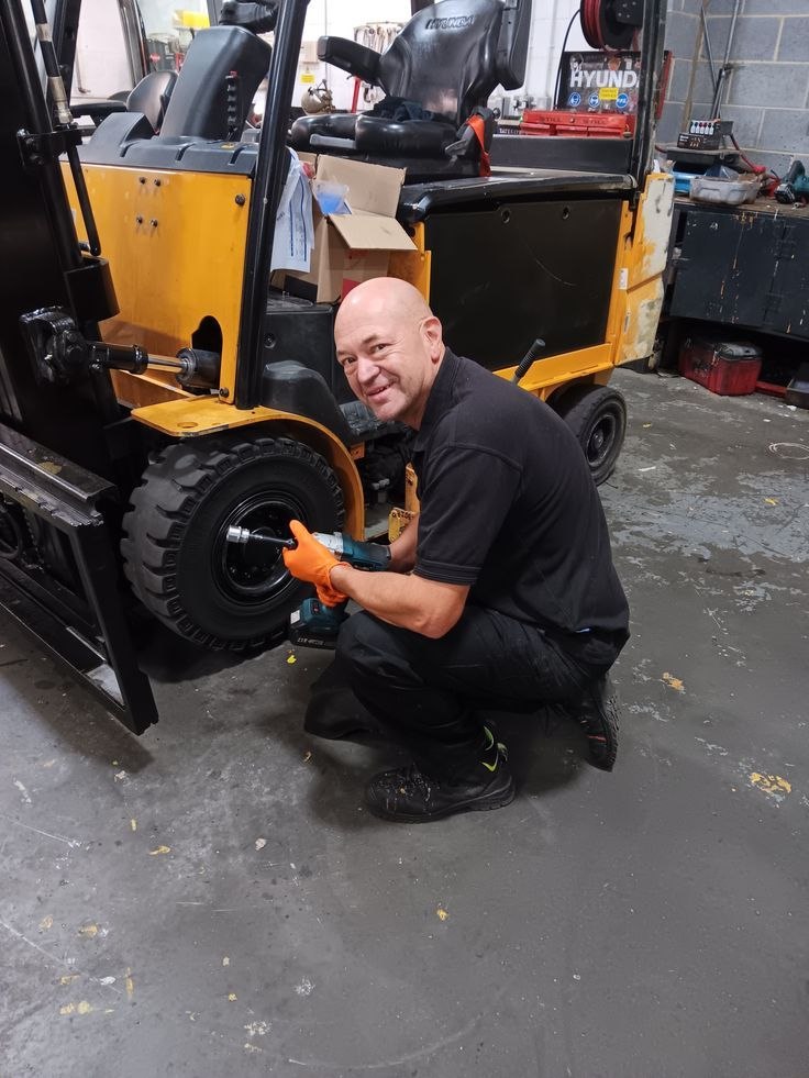 Technician repairing a forklift