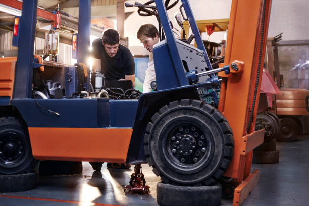 Technician servicing a forklift engine